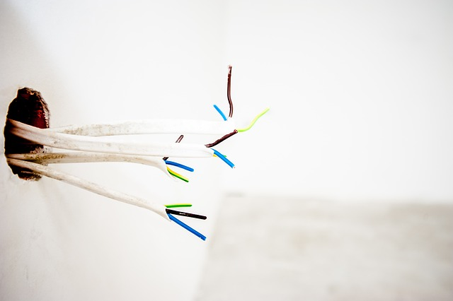 Image of loose wires through a wall location where an appliance may be plugged.