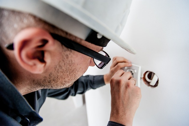 Image of electrician troubleshooting loose connections on one gfci outlet.