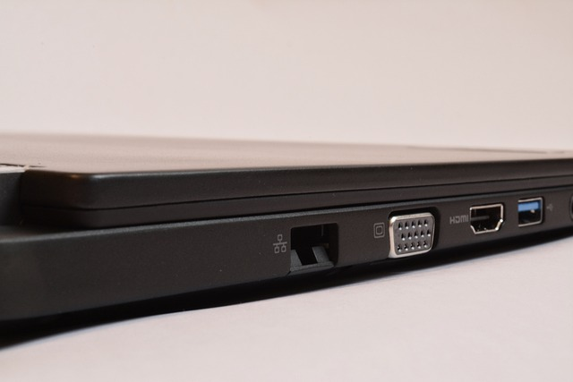 Laptop showing communication ports such as audio jack, sd card slot, display port for external monitor.